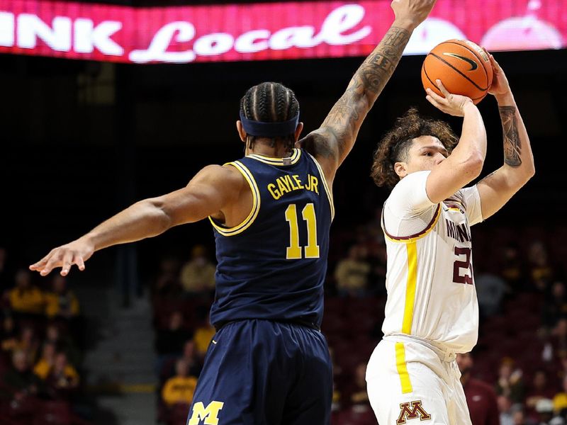 Jan 16, 2025; Minneapolis, Minnesota, USA; Minnesota Golden Gophers guard Lu'Cye Patterson (25) shoots as Michigan Wolverines guard Roddy Gayle Jr. (11) defends during the first half at Williams Arena. Mandatory Credit: Matt Krohn-Imagn Images
