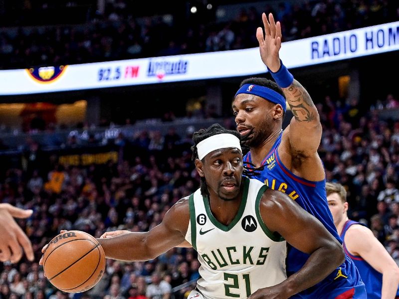 DENVER, CO - MARCH 25:  Jrue Holiday #21 of the Milwaukee Bucks is defended by Bruce Brown #11 of the Denver Nuggets in the second half of a game at Ball Arena on March 25, 2023 in Denver, Colorado. NOTE TO USER: User expressly acknowledges and agrees that, by downloading and or using this photograph, User is consenting to the terms and conditions of the Getty Images License Agreement. (Photo by Dustin Bradford/Getty Images)