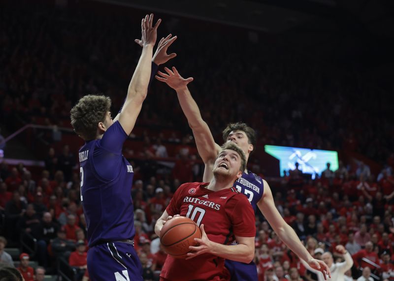 Mar 5, 2023; Piscataway, New Jersey, USA; Rutgers Scarlet Knights guard Cam Spencer (10) drives to the basket as Northwestern Wildcats guard Brooks Barnhizer (13) and forward Nick Martinelli (2) defend during the second half at Jersey Mike's Arena. Mandatory Credit: Vincent Carchietta-USA TODAY Sports