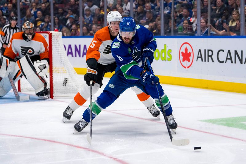 Oct 11, 2024; Vancouver, British Columbia, CAN; Philadelphia Flyers defenseman Egor Zamula (5) defends against Vancouver Canucks forward Conor Garland (8) during the third period at Rogers Arena. Mandatory Credit: Bob Frid-Imagn Images