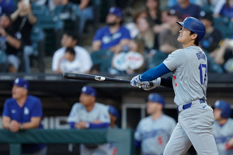 Jun 26, 2024; Chicago, Illinois, USA; Los Angeles Dodgers designated hitter Shohei Ohtani (17) watches his solo home run against the Chicago White Sox during the first inning at Guaranteed Rate Field. Mandatory Credit: Kamil Krzaczynski-USA TODAY Sports