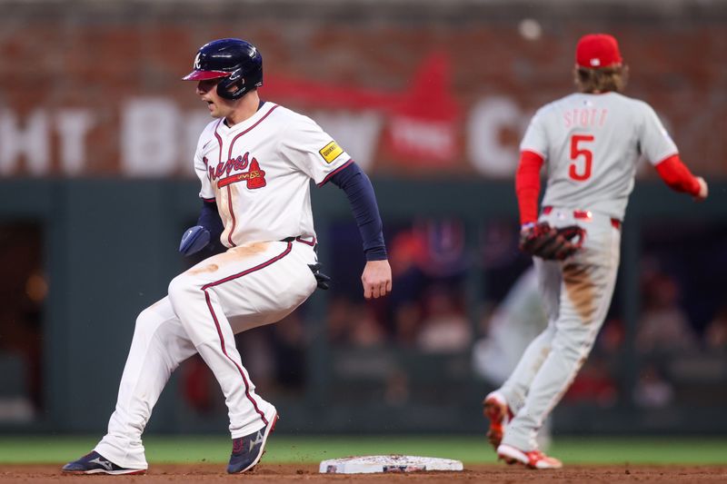 Apr 10, 2025; Atlanta, Georgia, USA; Atlanta Braves third baseman Austin Riley (27) runs past second base against the Philadelphia Phillies in the third inning at Truist Park. Mandatory Credit: Brett Davis-Imagn Images

