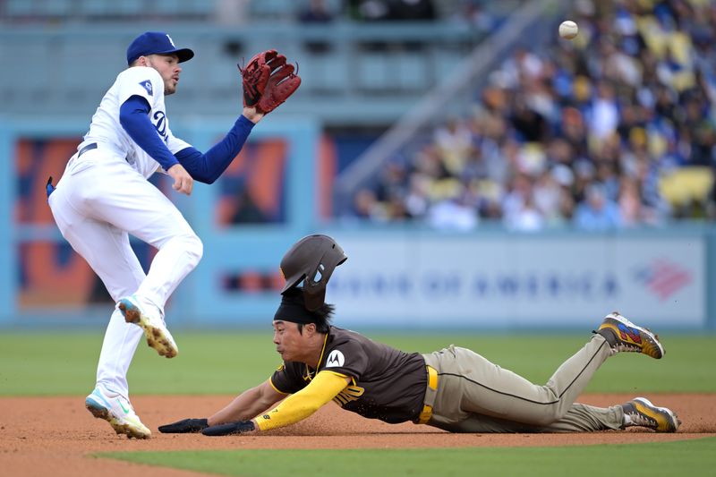 Apr 14, 2024; Los Angeles, California, USA; San Diego Padres shortstop Ha-Seong Kim (7)is tagged out by Los Angeles Dodgers second base Gavin Lux (9) on an attempted stolen base in the second inning at Dodger Stadium. Mandatory Credit: Jayne Kamin-Oncea-USA TODAY Sports