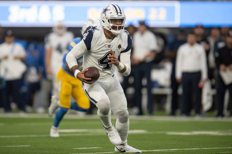 Dallas Cowboys quarterback Dak Prescott (4) runs with the ball during an NFL football game against the Los Angeles Chargers, Monday, Oct. 16, 2023, in Inglewood, Calif. (AP Photo/Kyusung Gong)