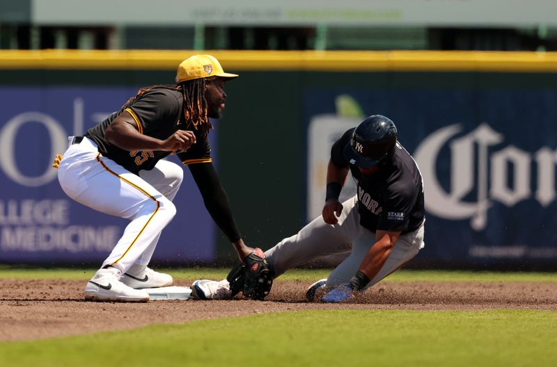 Mar 24, 2024; Bradenton, Florida, USA;  Pittsburgh Pirates shortstop Oneil Cruz (15) tags out New York Yankees left fielder Jahmai Jones (85) during the first inning at LECOM Park. Mandatory Credit: Kim Klement Neitzel-USA TODAY Sports