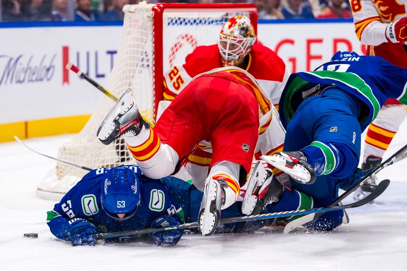 Apr 16, 2024; Vancouver, British Columbia, CAN; Calgary Flames forward Jonathan Huberdeau (10) collides with Vancouver Canucks forward Teddy Blueger (53) and forward Vasily Podkolzin (92) in the third period at Rogers Arena. Canucks won 4 -1. Mandatory Credit: Bob Frid-USA TODAY Sports