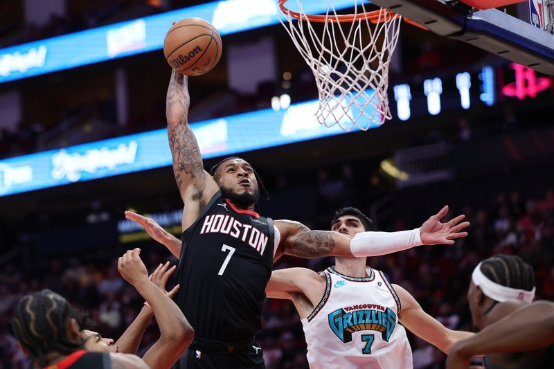 HOUSTON, TEXAS - JANUARY 13: Cam Whitmore #7 of the Houston Rockets dunks the ball against Santi Aldama #7 of the Memphis Grizzlies during the first half at Toyota Center on January 13, 2025 in Houston, Texas. NOTE TO USER: User expressly acknowledges and agrees that, by downloading and or using this photograph, User is consenting to the terms and conditions of the Getty Images License Agreement. (Photo by Alex Slitz/Getty Images)