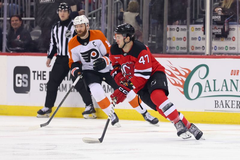 Jan 18, 2025; Newark, New Jersey, USA; New Jersey Devils center Paul Cotter (47) skates with the puck against the Philadelphia Flyers during the first period at Prudential Center. Mandatory Credit: Ed Mulholland-Imagn Images