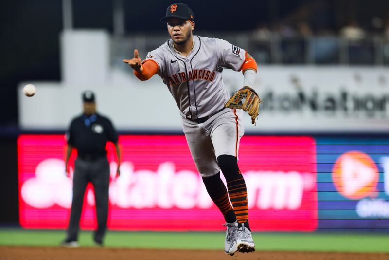 Apr 17, 2024; Miami, Florida, USA; San Francisco Giants second baseman Thairo Estrada (39) tosses the ball to first baseman Wilmer Flores (not pictured) and retires Miami Marlins second base Luis Arraez (not pictured) during the third inning at loanDepot Park. Mandatory Credit: Sam Navarro-USA TODAY Sports