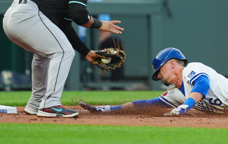 Jul 22, 2024; Kansas City, Missouri, USA; Kansas City Royals left fielder Drew Waters (6) slides safely into third base against Arizona Diamondbacks third baseman Eugenio Suarez (28) during the second inning at Kauffman Stadium. Mandatory Credit: Jay Biggerstaff-USA TODAY Sports