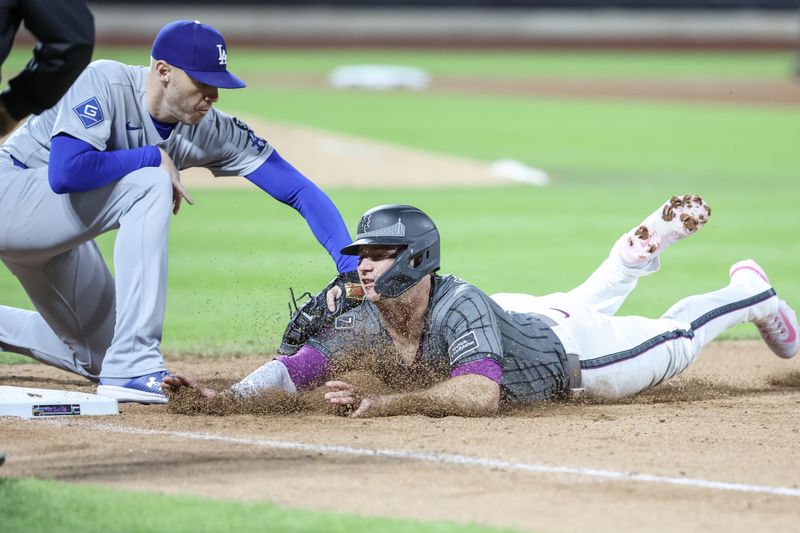 May 24, 2025; New York City, New York, USA;  New York Mets first baseman Pete Alonso (20) is tagged out by Los Angeles Dodgers first baseman Freddie Freeman (5) on a pick off play in the seventh inning  at Citi Field. Mandatory Credit: Wendell Cruz-Imagn Images
