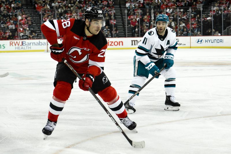 Nov 10, 2024; Newark, New Jersey, USA; New Jersey Devils right wing Timo Meier (28) skates with the puck against San Jose Sharks center Luke Kunin (11) during the second period at Prudential Center. Mandatory Credit: John Jones-Imagn Images