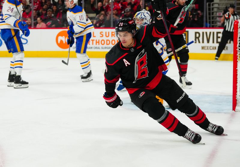 Dec 2, 2023; Raleigh, North Carolina, USA; Carolina Hurricanes center Sebastian Aho (20) scores a goal against the Buffalo Sabres during the first period at PNC Arena. Mandatory Credit: James Guillory-USA TODAY Sports