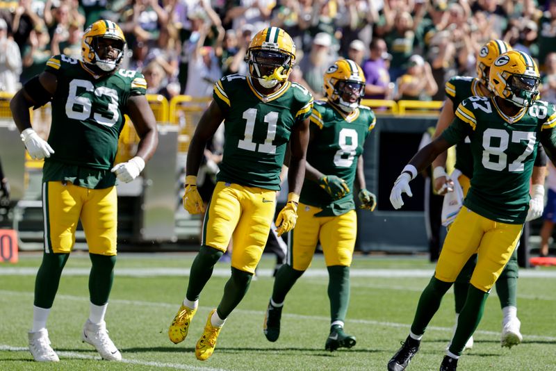 Green Bay Packers wide receiver Jayden Reed (11) celebrates a touchdown during the first half of an NFL football game against the Minnesota Vikings, Sunday, Sept. 29, 2024, in Green Bay, Wis. (AP Photo/Mike Roemer)