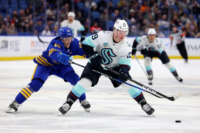 Jan 9, 2024; Buffalo, New York, USA;  Buffalo Sabres defenseman Henri Jokiharju (10) and Seattle Kraken defenseman Vince Dunn (29) go after a loose puck during the first period at KeyBank Center. Mandatory Credit: Timothy T. Ludwig-USA TODAY Sports