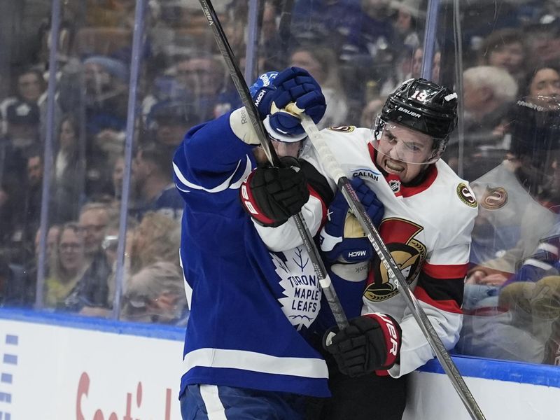 Dec 27, 2025; Toronto, Ontario, CAN; Toronto Maple Leafs defenseman Oliver Ekman-Larsson (95) checks Ottawa Senators forward Drake Batherson (19) into the boards during the second period at Scotiabank Arena. Mandatory Credit: John E. Sokolowski-Imagn Images