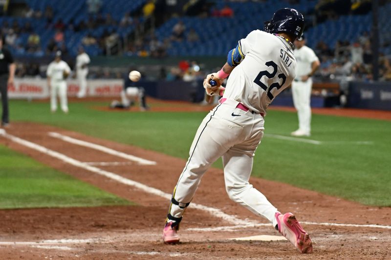 May 29, 2024; St. Petersburg, Florida, USA; Tampa Bay Rays center fielder Jose Siri (22) drives in the game winning run with a RBI single in the ninth inning against the Oakland Athletics  at Tropicana Field. Mandatory Credit: Jonathan Dyer-USA TODAY Sports