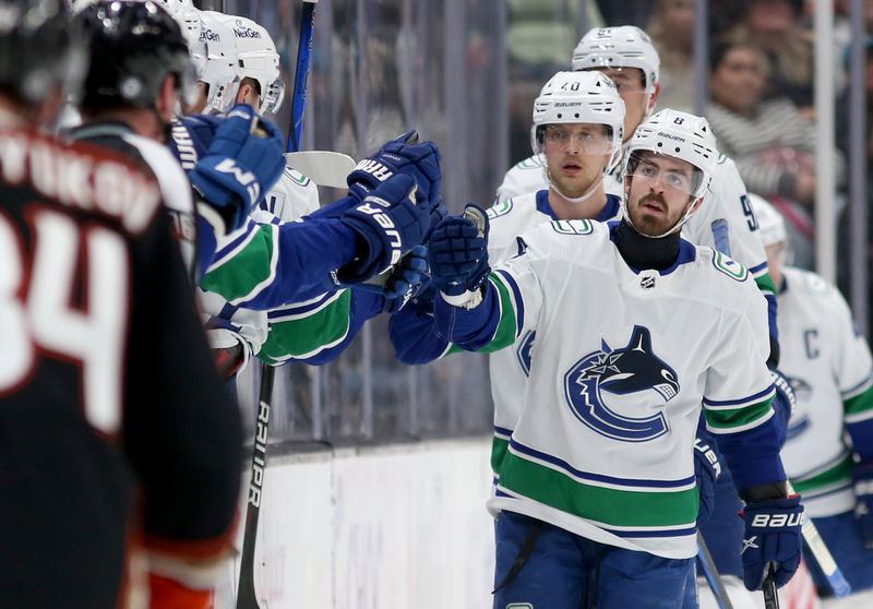 Mar 3, 2024; Anaheim, California, USA; Vancouver Canucks right wing Conor Garland (8) celebrates with teammates after a goal during the second period against the Anaheim Ducksa at Honda Center. Mandatory Credit: Jason Parkhurst-USA TODAY Sports