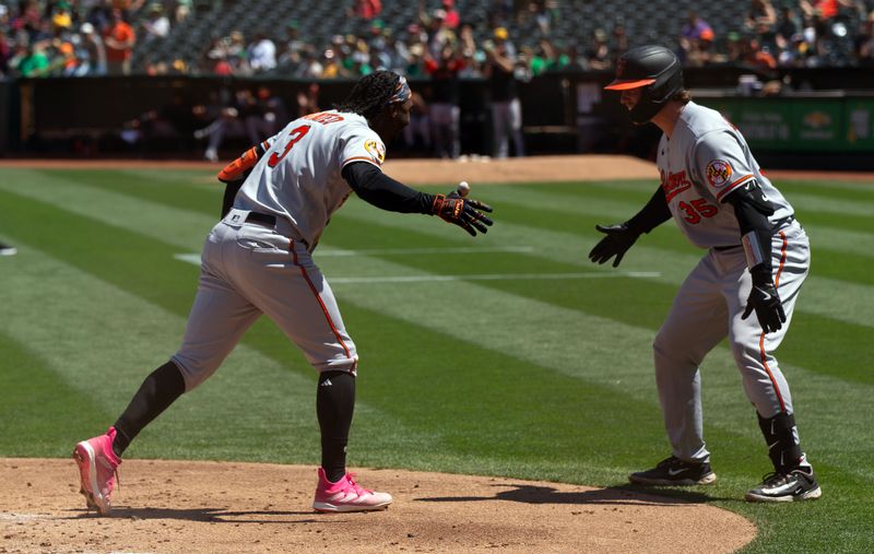Aug 20, 2023; Oakland, California, USA; Baltimore Orioles shortstop Jorge Mateo (3) celebrates his inside-the-park home run against the Oakland Athletics with teammate Adley Rutschman during the first inning at Oakland-Alameda County Coliseum. Mandatory Credit: D. Ross Cameron-USA TODAY Sports