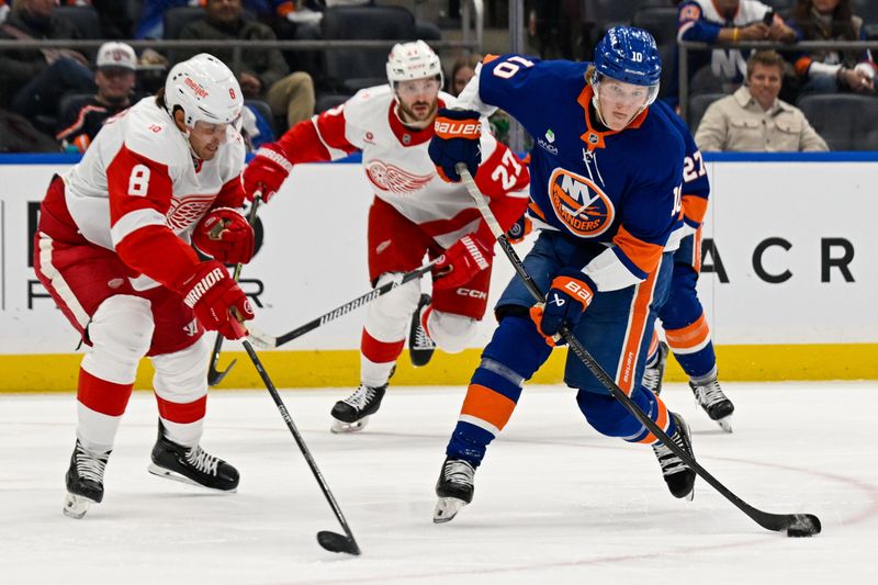 Oct 23, 2025; Elmont, New York, USA;  New York Islanders right wing Simon Holmstrom (10) attempts shot defended by Detroit Red Wings defenseman Ben Chiarot (8) during the second period at UBS Arena. Mandatory Credit: Dennis Schneidler-Imagn Images