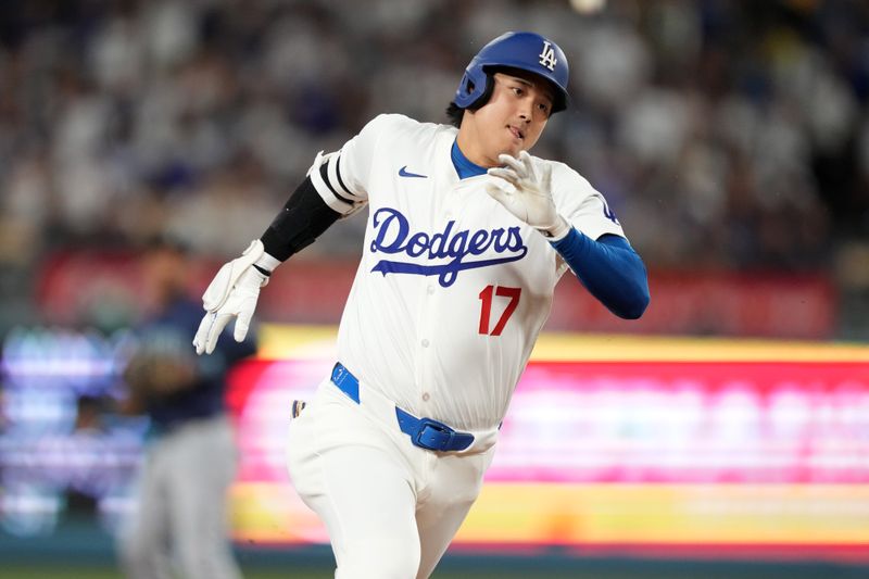 Aug 20, 2024; Los Angeles, California, USA; Los Angeles Dodgers designated hitter Shohei Ohtani (17) runs the bases after hitting a triple in the third inning against the Seattle Mariners at Dodger Stadium. Mandatory Credit: Kirby Lee-USA TODAY Sports