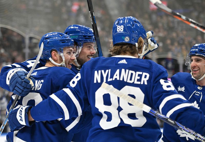 Jan 3, 2023; Toronto, Ontario, CAN;  Toronto Maple Leafs forward Michael Bunting (58) celebrates with teammates after scoring against the St. Louis Blues in the third period at Scotiabank Arena. Mandatory Credit: Dan Hamilton-USA TODAY Sports