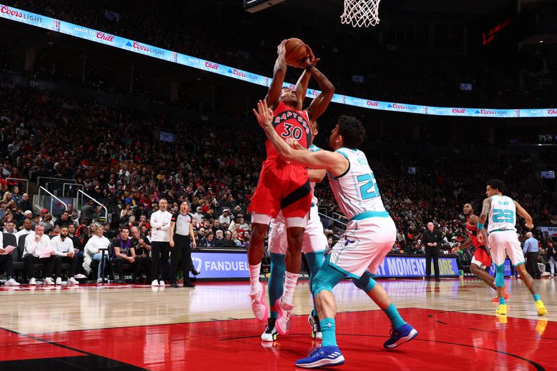 TORONTO, CANADA - MARCH 3: Ochai Agbaji #30 of the Toronto Raptors drives to the basket during the game against the Charlotte Hornets on March 3, 2024 at the Scotiabank Arena in Toronto, Ontario, Canada.  NOTE TO USER: User expressly acknowledges and agrees that, by downloading and or using this Photograph, user is consenting to the terms and conditions of the Getty Images License Agreement.  Mandatory Copyright Notice: Copyright 2024 NBAE (Photo by Vaughn Ridley/NBAE via Getty Images)