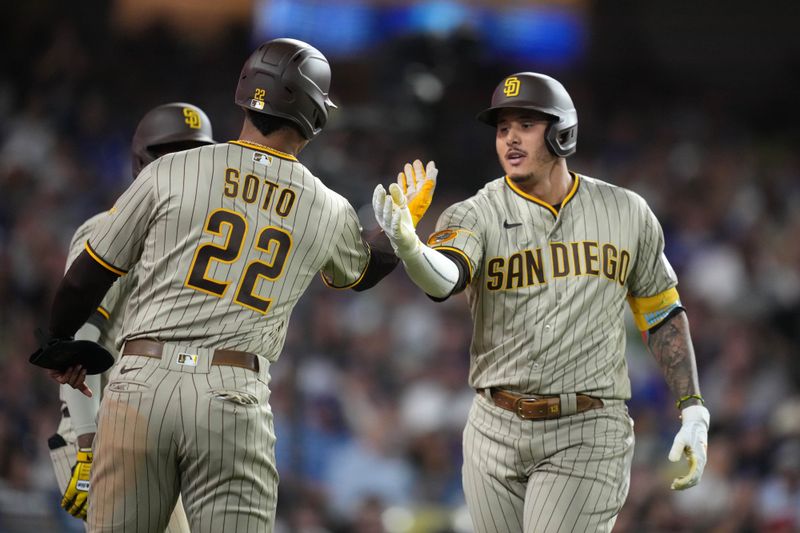 Sep 11, 2023; Los Angeles, California, USA; San Diego Padres designated hitter Manny Machado (13) celebrates with left fielder Juan Soto (22) after hitting a two-run home run in the sixth inning against the Los Angeles Dodgers at Dodger Stadium. Mandatory Credit: Kirby Lee-USA TODAY Sports