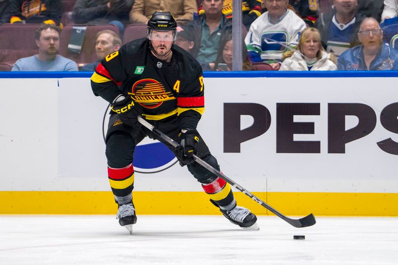 Mar 19, 2024; Vancouver, British Columbia, CAN; Vancouver Canucks forward J.T. Miller (9) handles the puck against the Buffalo Sabres in the first period at Rogers Arena. Mandatory Credit: Bob Frid-USA TODAY Sports