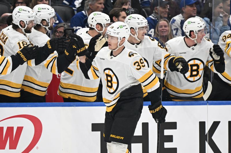 Nov 8, 2025; Toronto, Ontario, CAN;  Boston Bruins forward Morgan Geekie (39) celebrates with team mates at the bench after scoring a goal against the Toronto Maple Leafs in the first period at Scotiabank Arena. Mandatory Credit: Dan Hamilton-Imagn Images