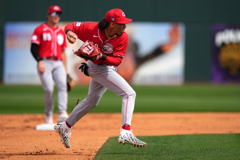 Feb. 24, 2024; Goodyear, Arizona, USA; Cincinnati Reds shortstop Edwin Arroyo fields a ground ball in the fifth inning during a MLB spring training baseball game against the Cleveland Guardians at Goodyear Ballpark. Mandatory Credit: Kareem Elgazzar-USA TODAY Sports