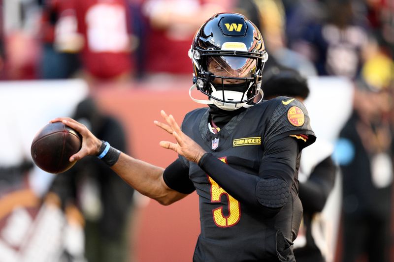 Washington Commanders quarterback Jayden Daniels warms up before an NFL football game against the Chicago Bears Sunday, Oct. 27, 2024, in Landover, Md. (AP Photo/Nick Wass)