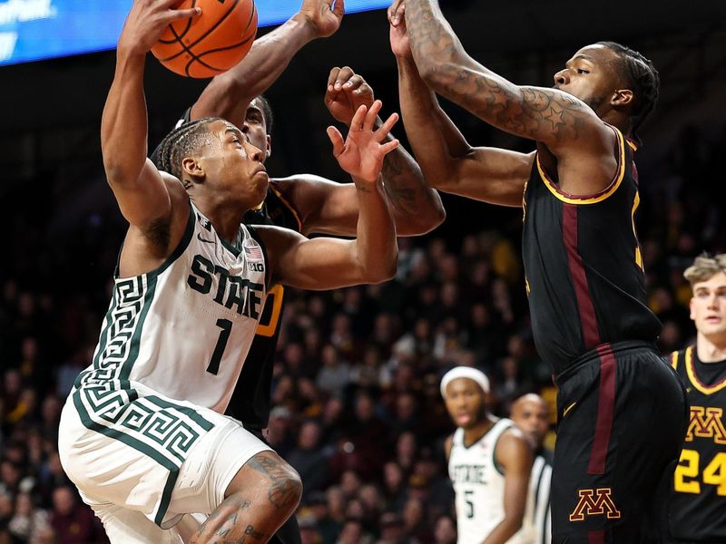 Dec 4, 2024; Minneapolis, Minnesota, USA; Michigan State Spartans guard Jeremy Fears Jr. (1) drives towards teh basket as Minnesota Golden Gophers guard Femi Odukale (11) defends during the second half at Williams Arena. Mandatory Credit: Matt Krohn-Imagn Images