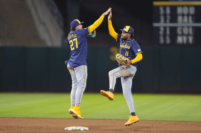 Aug 23, 2024; Oakland, California, USA; Milwaukee Brewers shortstop Willy Adames (27) celebrates with left fielder Jackson Chourio (11) after defeating the Oakland Athletics at Oakland-Alameda County Coliseum. Mandatory Credit: Darren Yamashita-USA TODAY Sports