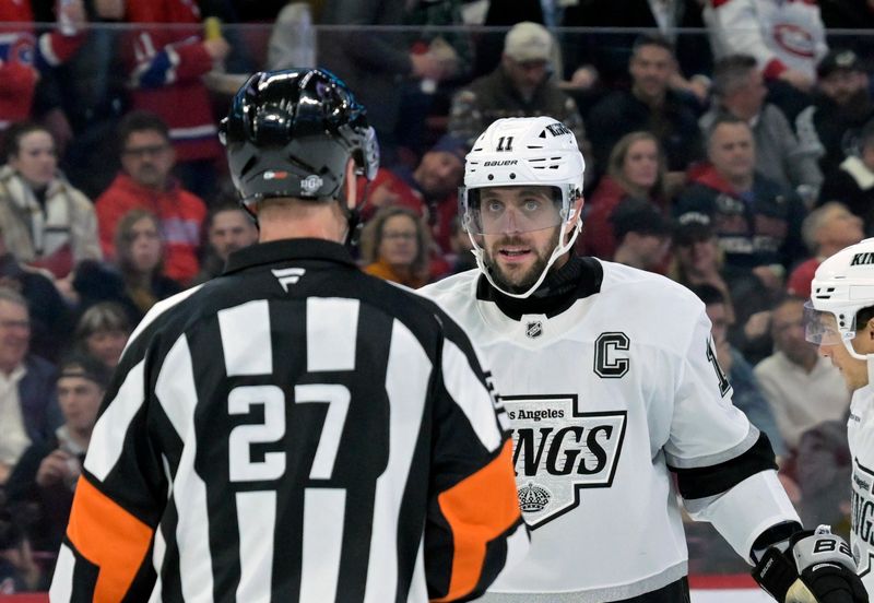 Oct 17, 2024; Montreal, Quebec, CAN; Los Angeles Kings forward Anze Kopitar (11) talks to referee Eric Furlatt (27) during the second period of the game against the Montreal Canadiens at the Bell Centre. Mandatory Credit: Eric Bolte-Imagn Images