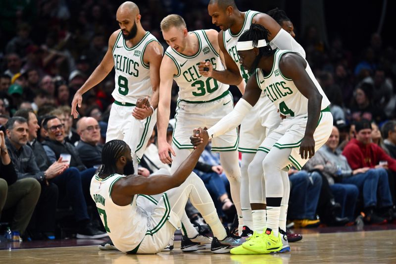 CLEVELAND, OHIO - MARCH 05: Derrick White #9 Sam Hauser #30 Al Horford #42 and Jrue Holiday #4 of the Boston Celtics help Jaylen Brown #7 of the Boston Celtics to his feet during the third quarter against the Cleveland Cavaliers at Rocket Mortgage Fieldhouse on March 05, 2024 in Cleveland, Ohio. The Cavaliers defeated the Celtics 105-104. NOTE TO USER: User expressly acknowledges and agrees that, by downloading and or using this photograph, User is consenting to the terms and conditions of the Getty Images License Agreement. (Photo by Jason Miller/Getty Images)