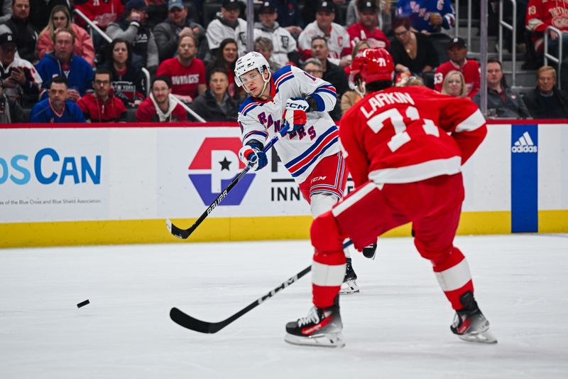 Apr 5, 2024; Detroit, Michigan, USA; New York Rangers left wing Artemi Panarin (10) shoots as Detroit Red Wings center Dylan Larkin (71) defends during the first period at Little Caesars Arena. Mandatory Credit: Tim Fuller-USA TODAY Sports