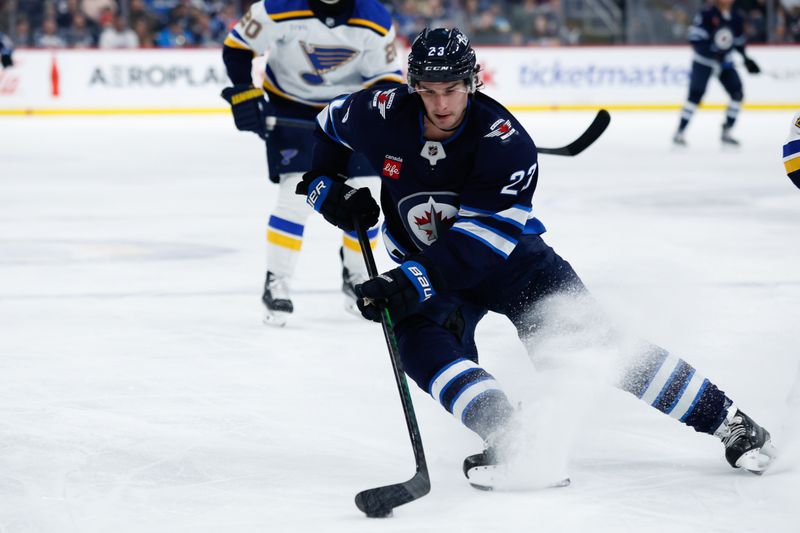 Feb 27, 2024; Winnipeg, Manitoba, CAN; Winnipeg Jets forward Sean Monahan (23) skates into the St. Louis Blues zone during the second period at Canada Life Centre. Mandatory Credit: Terrence Lee-USA TODAY Sports