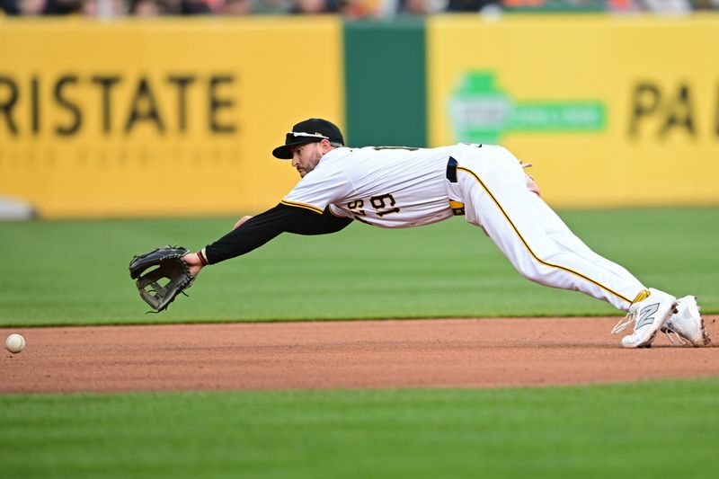 Apr 6, 2024; Pittsburgh, Pennsylvania, USA;  Baltimore Orioles pitcher Cole Irvin (19) dives for a ball during the seventh inning against the Baltimore Orioles at PNC Park. Mandatory Credit: David Dermer-USA TODAY Sports