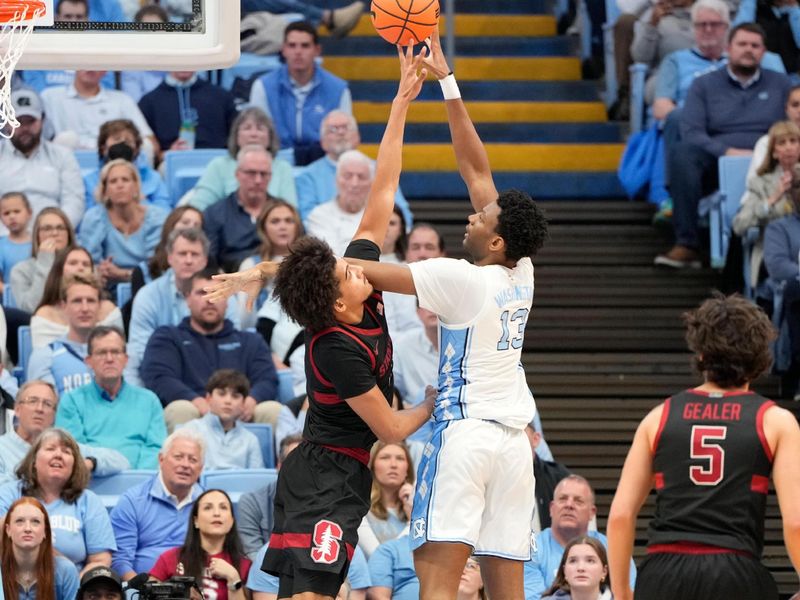 Jan 18, 2025; Chapel Hill, North Carolina, USA; North Carolina Tar Heels forward Jalen Washington (13) shoots as Stanford Cardinal forward Donavin Young (2) defends in the first half at Dean E. Smith Center. Mandatory Credit: Bob Donnan-Imagn Images
