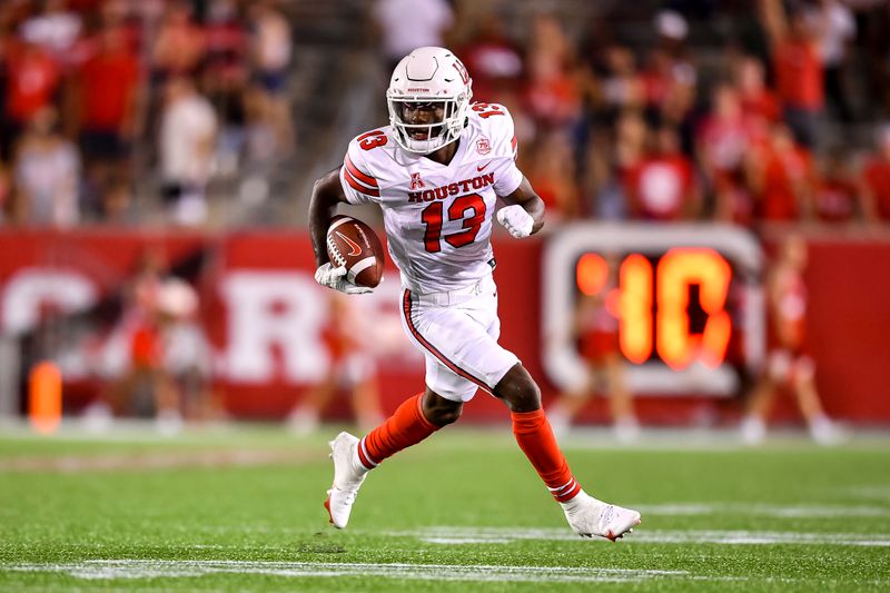 Sep 18, 2021; Houston, Texas, USA;  Houston Cougars wide receiver Jeremy Singleton (13) runs the ball against the Grambling State Tigers during the third quarter at TDECU Stadium. Mandatory Credit: Maria Lysaker-USA TODAY Sports