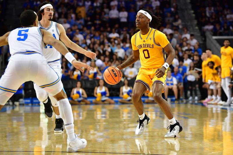 Mar 2, 2023; Los Angeles, California, USA; Arizona State Sun Devils guard DJ Horne (0) controls the ball against UCLA Bruins guard Amari Bailey (5) and guard Jaime Jaquez Jr. (24) during the first half at Pauley Pavilion. Mandatory Credit: Gary A. Vasquez-USA TODAY Sports