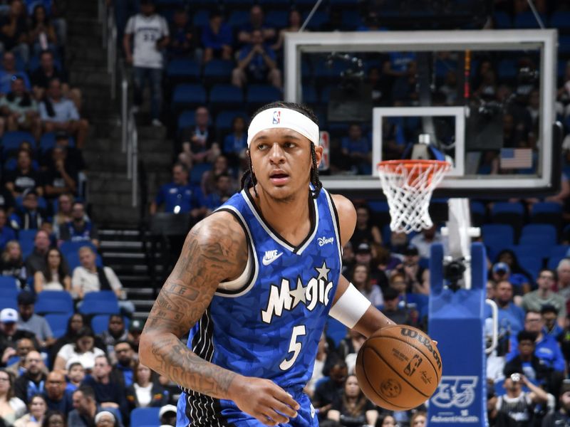 ORLANDO, FL - MARCH 23: Paolo Banchero #5 of the Orlando Magic handles the ball during the game against the Sacramento Kings on March 23, 2024 at the Kia Center in Orlando, Florida. NOTE TO USER: User expressly acknowledges and agrees that, by downloading and or using this photograph, User is consenting to the terms and conditions of the Getty Images License Agreement. Mandatory Copyright Notice: Copyright 2024 NBAE (Photo by Fernando Medina/NBAE via Getty Images)