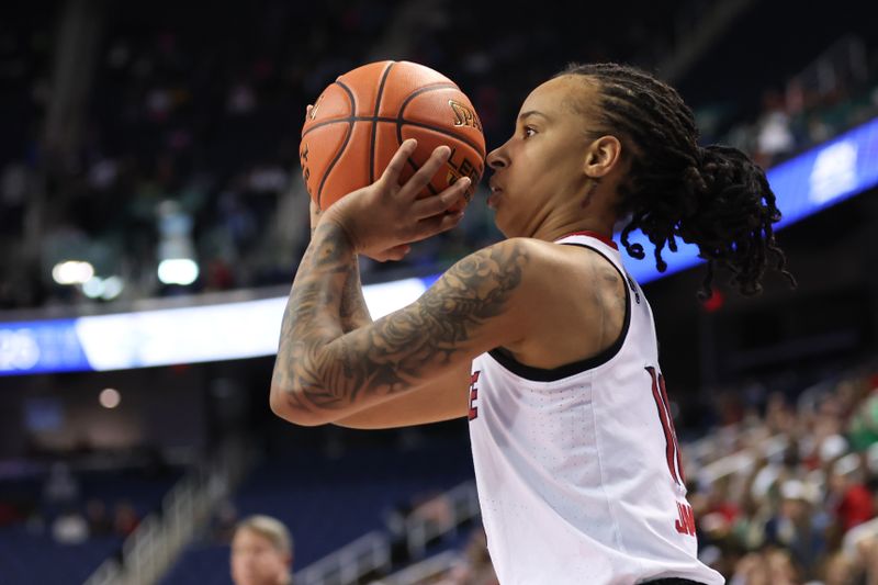 Mar 7, 2025; Greensboro, NC, USA;  NC State Wolfpack guard Aziaha James (10) attempts a three point shot against Georgia Tech Yellow Jackets during the third quarter at First Horizon Coliseum. Mandatory Credit: Cory Knowlton-Imagn Images