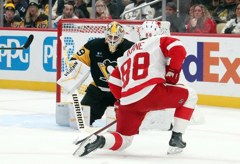 Nov 13, 2024; Pittsburgh, Pennsylvania, USA;  Detroit Red Wings right wing Patrick Kane (88) scores a goal against Pittsburgh Penguins goaltender Alex Nedeljkovic (39) during the second period at PPG Paints Arena. Mandatory Credit: Charles LeClaire-Imagn Images