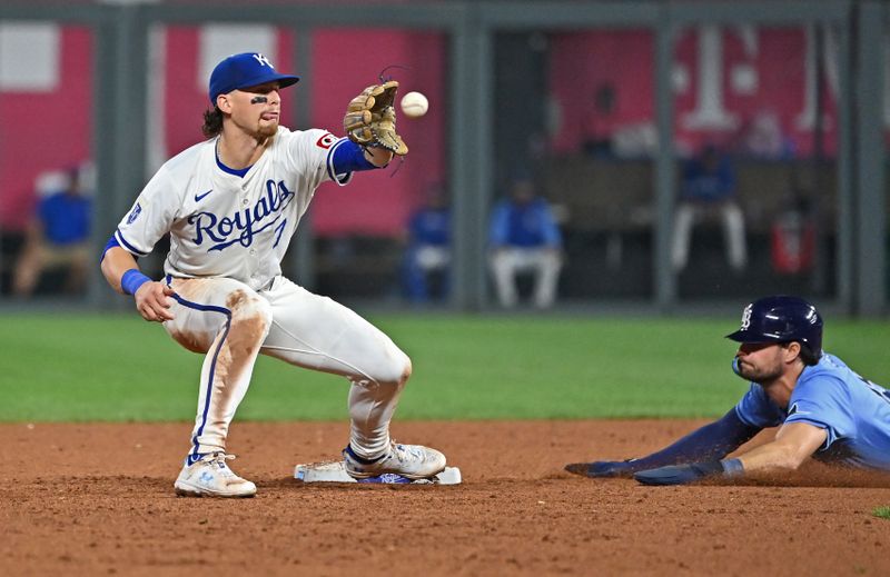Jul 3, 2024; Kansas City, Missouri, USA;  Kansas City Royals shortstop Bobby Witt Jr. (7) takes a throw at second base, as Tampa Bay Rays right fielder Josh Lowe (15) steals second in the eighth inning at Kauffman Stadium. Mandatory Credit: Peter Aiken-USA TODAY Sports