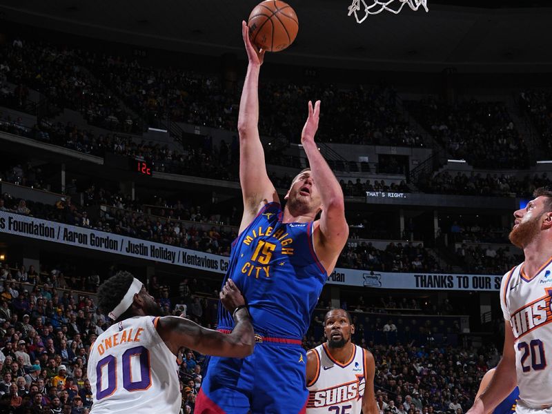 DENVER, CO - MARCH 5: Nikola Jokic #15 of the Denver Nuggets drives to the basket during the game against the Phoenix Suns on March 5, 2024 at the Ball Arena in Denver, Colorado. NOTE TO USER: User expressly acknowledges and agrees that, by downloading and/or using this Photograph, user is consenting to the terms and conditions of the Getty Images License Agreement. Mandatory Copyright Notice: Copyright 2024 NBAE (Photo by Garrett Ellwood/NBAE via Getty Images)