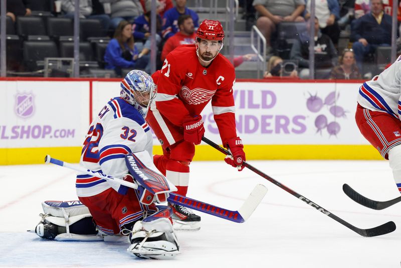 Nov 9, 2024; Detroit, Michigan, USA;  New York Rangers goaltender Jonathan Quick (32) makes a save in front of Detroit Red Wings center Dylan Larkin (71) in the second period at Little Caesars Arena. Mandatory Credit: Rick Osentoski-Imagn Images