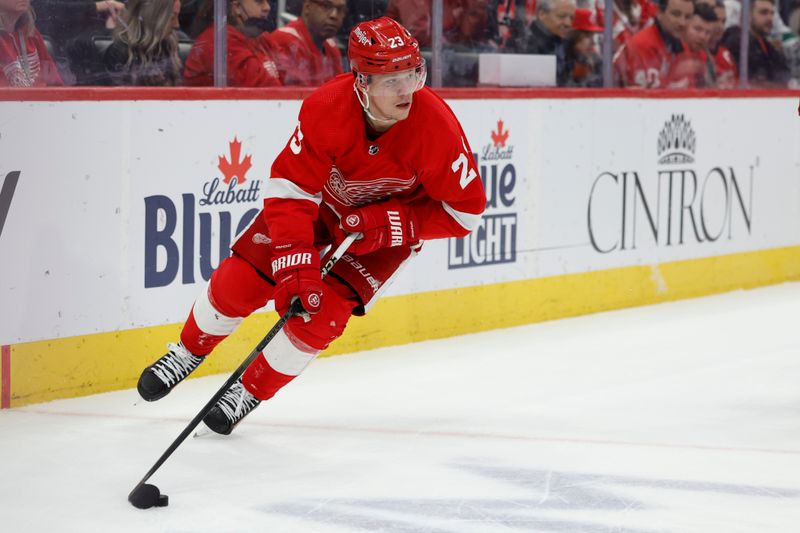 Feb 22, 2024; Detroit, Michigan, USA;  Detroit Red Wings left wing Lucas Raymond (23) skates with the puck in the second period against the Colorado Avalanche at Little Caesars Arena. Mandatory Credit: Rick Osentoski-USA TODAY Sports