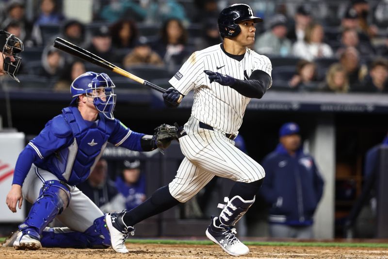 Apr 6, 2024; Bronx, New York, USA; New York Yankees right fielder Juan Soto (22) hits an RBI single in the sixth inning against the Toronto Blue Jays at Yankee Stadium. Mandatory Credit: Wendell Cruz-USA TODAY Sports